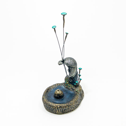 Silver-bronze bird incense holder with turquoise fungi and textured basin.
